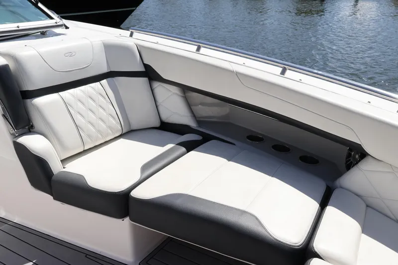 Slide: The Image of Luxurious seating on 2022 Regal 33 OBX boat, featuring elegant white and black upholstery. - 42