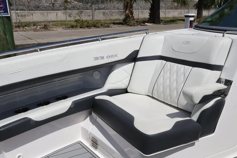 Slide: The Image of 2022 Regal 33 OBX boat interior with luxurious white seating and cup holders. - 43