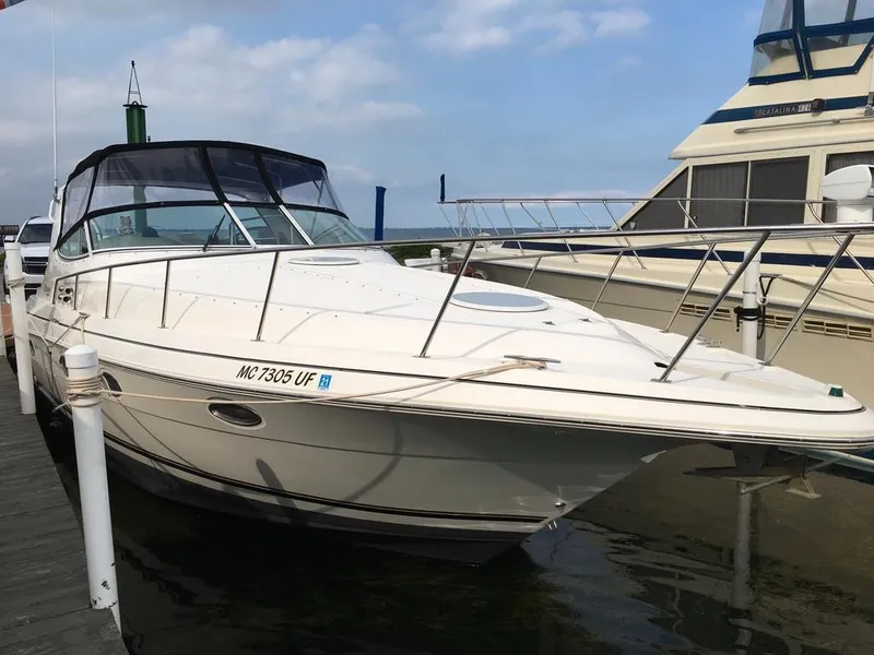 The Image of 2004 Cruisers Yachts 3372 Express docked, calm water. - 0