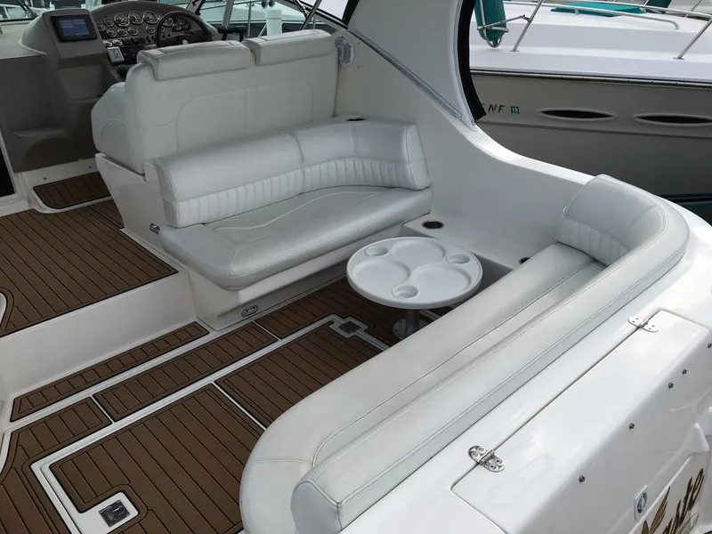 Slide: The Image of Interior of a 2004 Cruisers Yachts 3372 Express with white leather seating. - 14