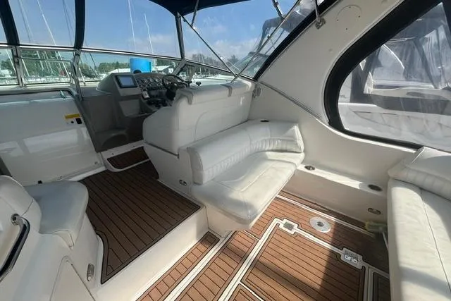 Slide: The Image of 2004 Cruisers Yachts 3372 Express interior with white seating and wood flooring. - 18