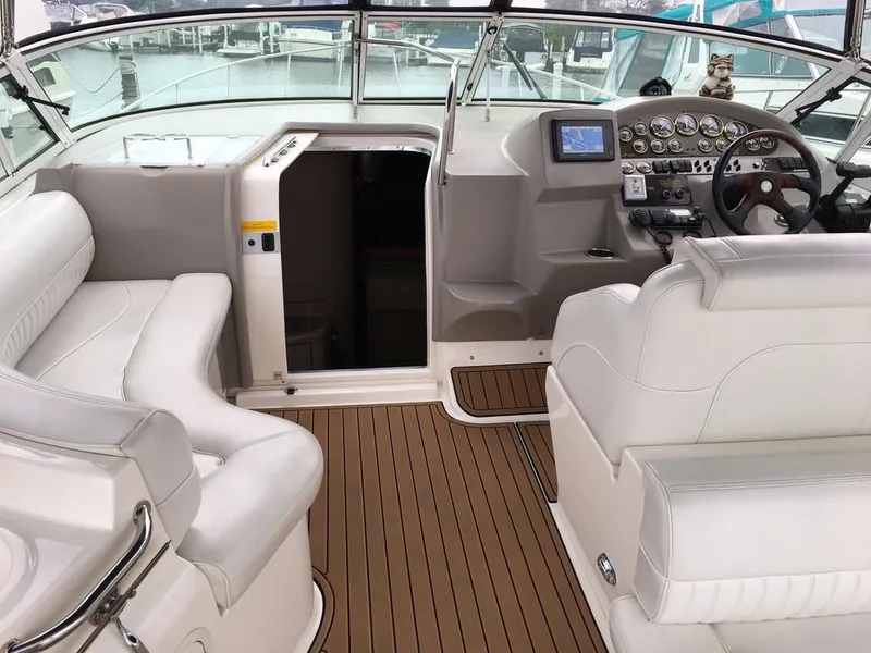 Slide: The Image of Interior of a 2004 Cruisers Yachts 3372 Express with white leather and wood accents. - 24