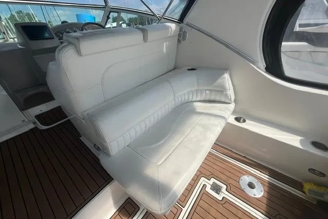Slide: The Image of 2004 Cruisers Yachts 3372 Express interior with white seating and wooden flooring. - 26