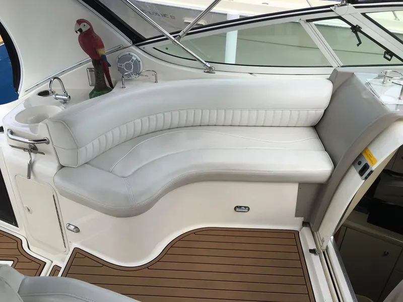 Slide: The Image of Interior of a 2004 Cruisers Yachts 3372 Express with white seating area. - 27