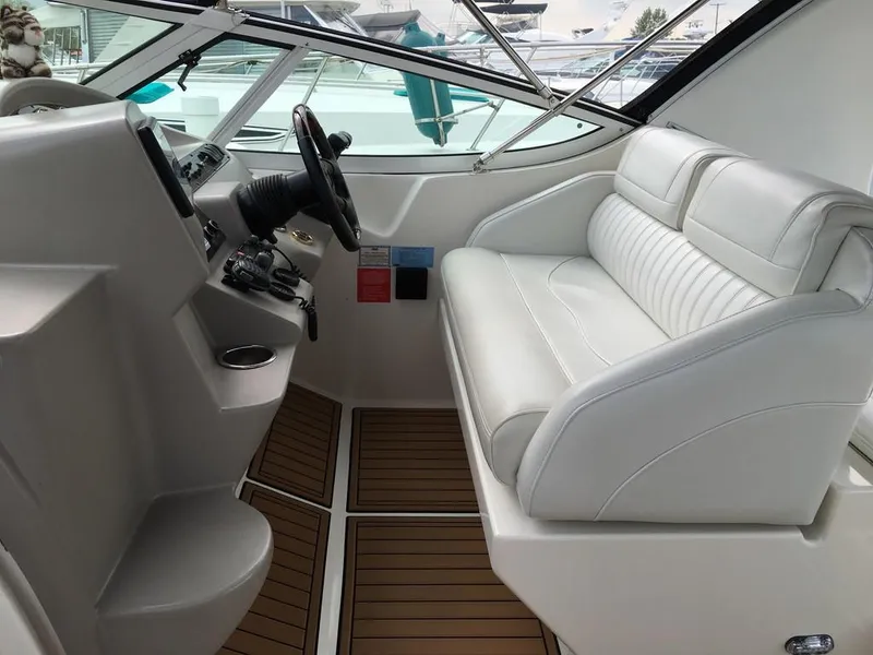 Slide: The Image of Interior of a 2004 Cruisers Yachts 3372 Express with white seating. - 28