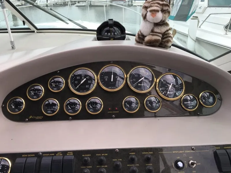 Slide: The Image of Dashboard of a 2004 Cruisers Yachts 3372 Express with plush toy. - 30