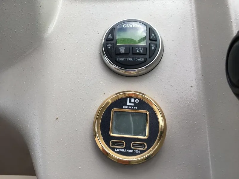 Slide: The Image of 2004 Cruisers Yachts 3372 Express dashboard with Clarion and Lowrance instruments. - 36