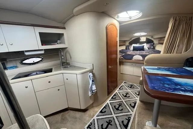 Slide: The Image of Interior of 2004 Cruisers Yachts 3372 Express with kitchenette and cozy sleeping area. - 42