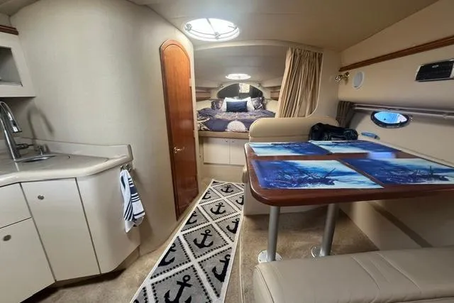 Slide: The Image of 2004 Cruisers Yachts 3372 Express cabin interior with kitchenette and dining area. - 43