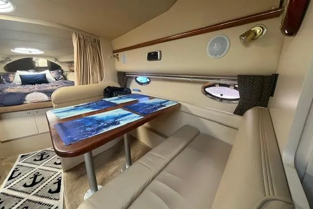 Slide: The Image of Interior of 2004 Cruisers Yachts 3372 Express with dining area and cozy sleeping quarters. - 44