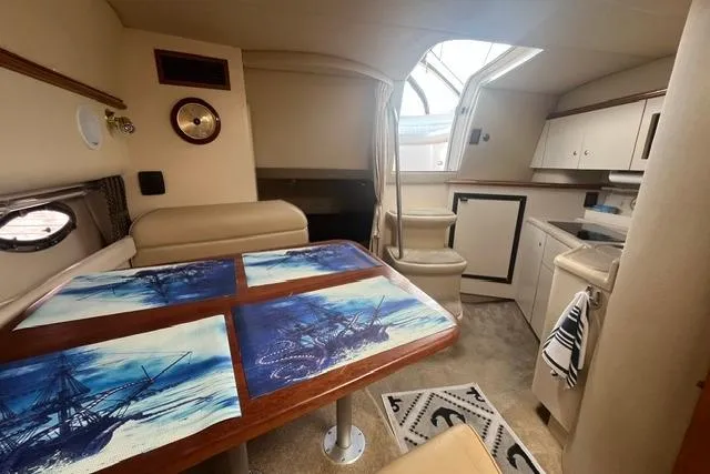 Slide: The Image of Interior of 2004 Cruisers Yachts 3372 Express with dining area and kitchenette. - 46
