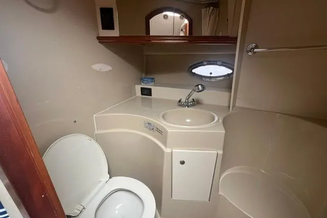 Slide: The Image of 2004 Cruisers Yachts 3372 Express bathroom with sink, toilet, and mirror. - 48