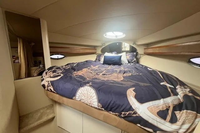 Slide: The Image of Interior cabin of 2004 Cruisers Yachts 3372 Express with nautical-themed bedding. - 49
