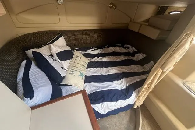 Slide: The Image of Interior cabin of 2004 Cruisers Yachts 3372 Express with striped bedding and nautical decor. - 60