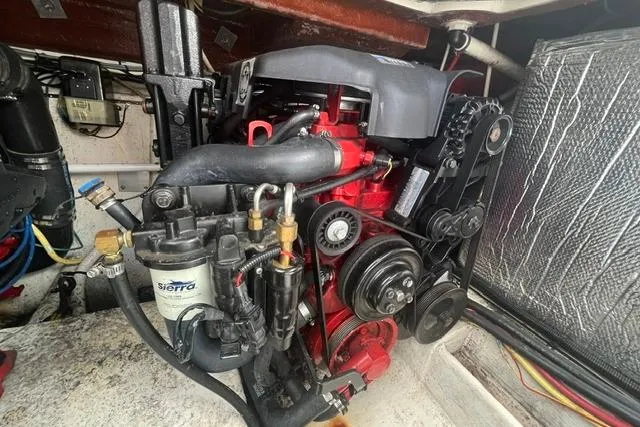 Slide: The Image of Engine compartment of a 2004 Cruisers Yachts 3372 Express, showcasing mechanical components. - 64