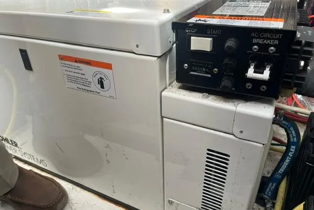 Slide: The Image of Electrical panel and generator system on a 2004 Cruisers Yachts 3372 Express. - 68
