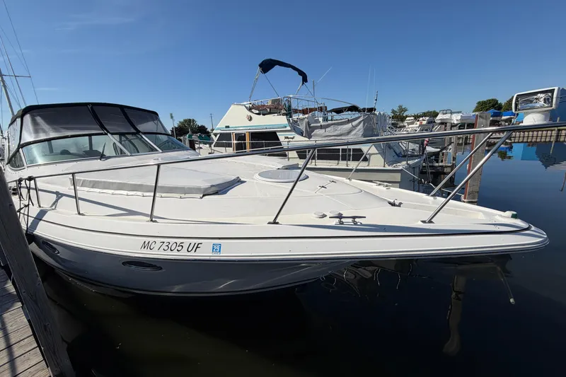 Slide: The Image of 2004 Cruisers Yachts 3372 Express docked at marina under clear blue sky. - 7