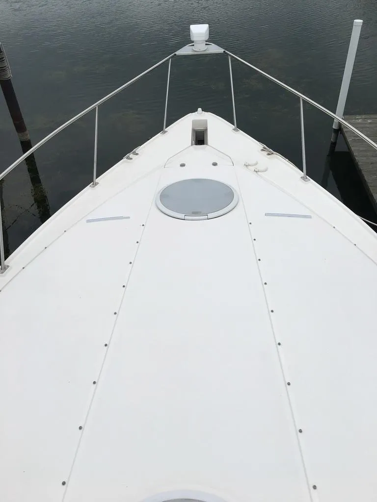 Slide: The Image of 2004 Cruisers Yachts 3372 Express on calm water. - 9
