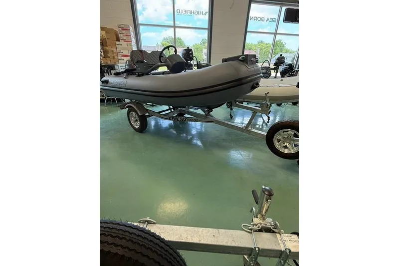 Slide: The Image of Desner CL310 FCT boat on trailer in showroom, 2026 model. - 0
