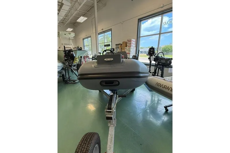 Slide: The Image of 2026 Desner CL310 FCT boat displayed indoors on a trailer. - 5