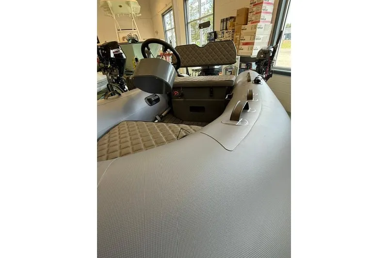 Slide: The Image of Interior of a 2026 Desner CL310 FCT boat, featuring quilted seating and modern controls. - 7