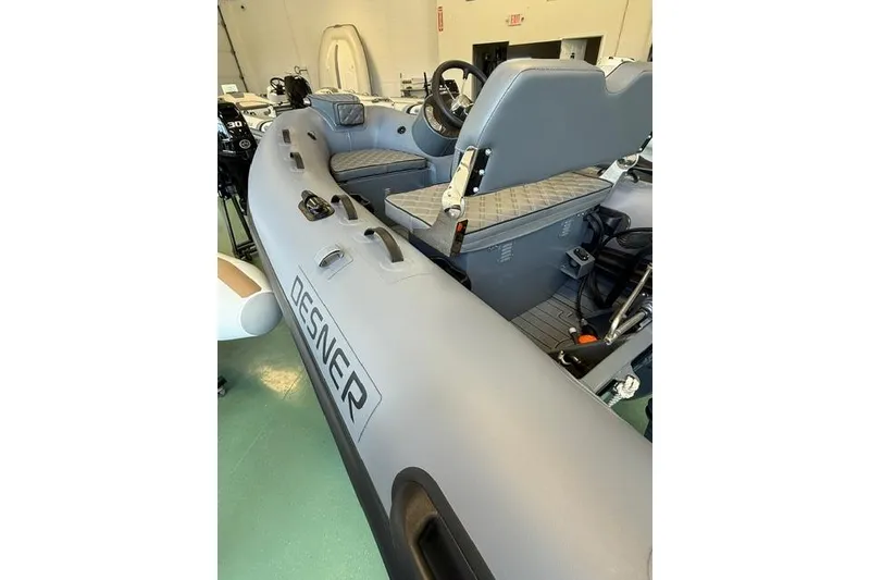 Slide: The Image of 2026 Desner CL310 FCT inflatable boat interior with steering console and seating. - 8