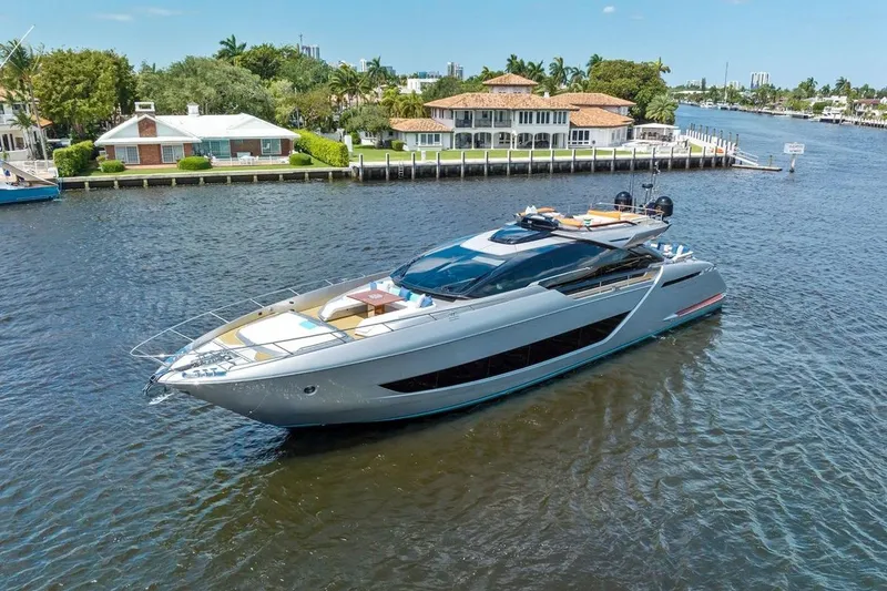 Slide: The Image of Luxury 2022 Riva 88' Folgore yacht cruising near waterfront homes. - 1