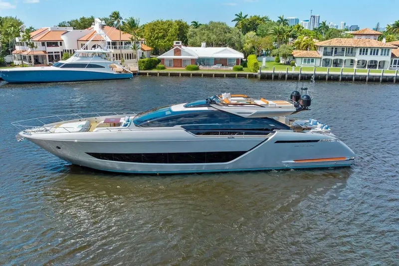 Slide: The Image of Luxury 2022 Riva 88' Folgore yacht cruising on a scenic waterfront. - 2