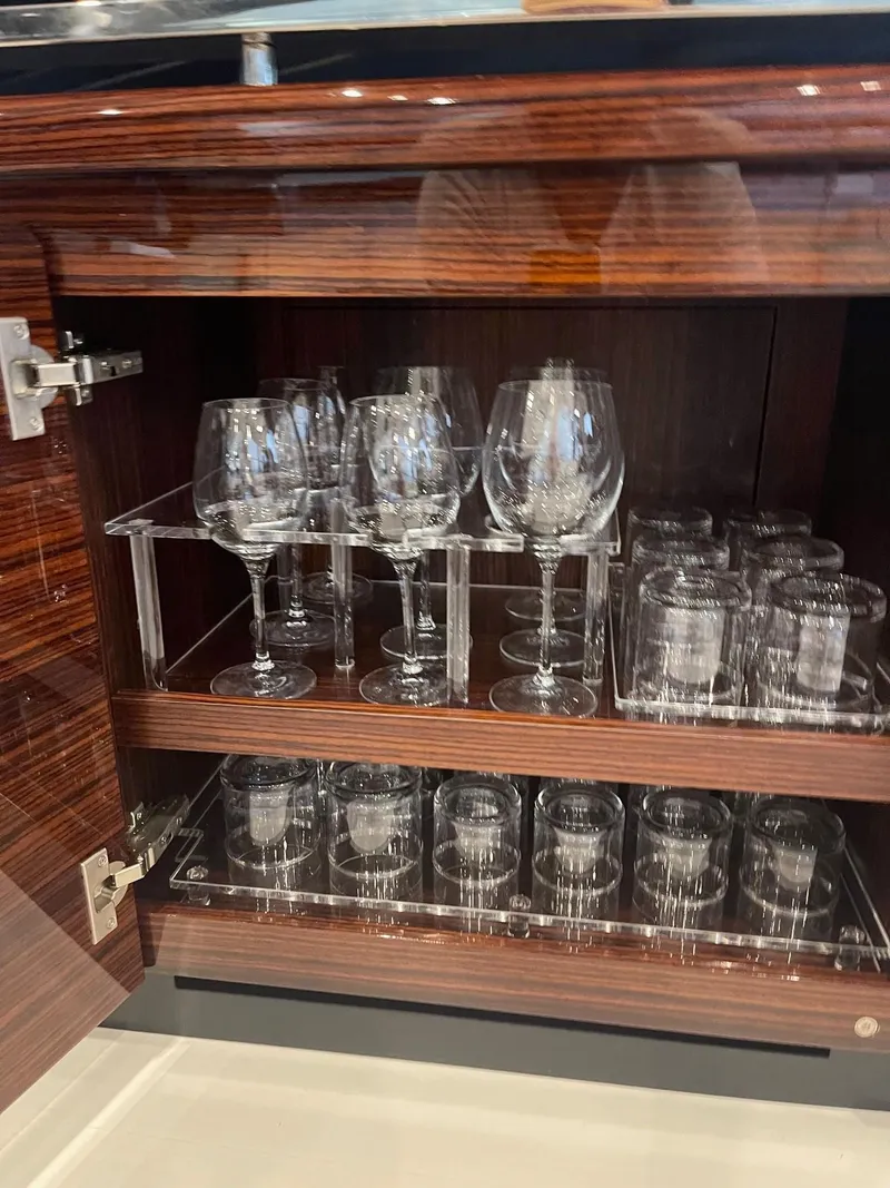 Slide: The Image of Glasses in a cabinet on the Riva 88' Folgore yacht. - 35