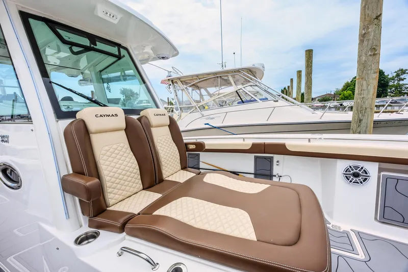 Slide: The Image of 2024 Caymas 34 CT boat with luxurious seating at a marina. - 10