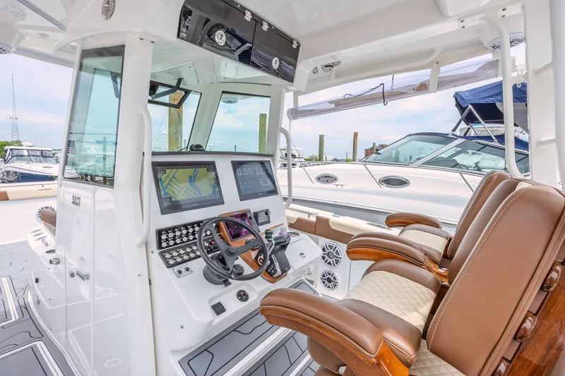 Slide: The Image of 2024 Caymas 34 CT boat cockpit with advanced navigation system and luxurious seating. - 11