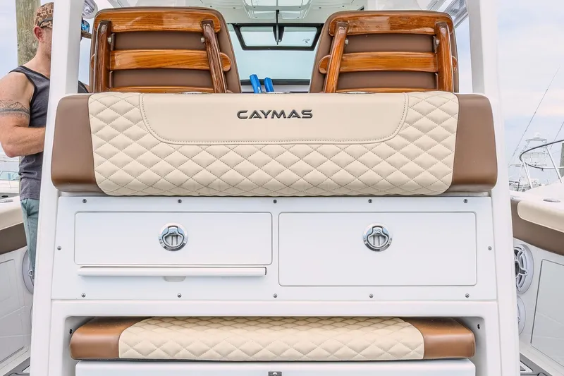 Slide: The Image of 2024 Caymas 34 CT boat interior with quilted seating and storage compartments. - 12