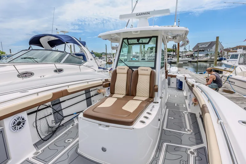 Slide: The Image of 2024 Caymas 34 CT boat docked, featuring luxurious seating and advanced navigation equipment. - 14