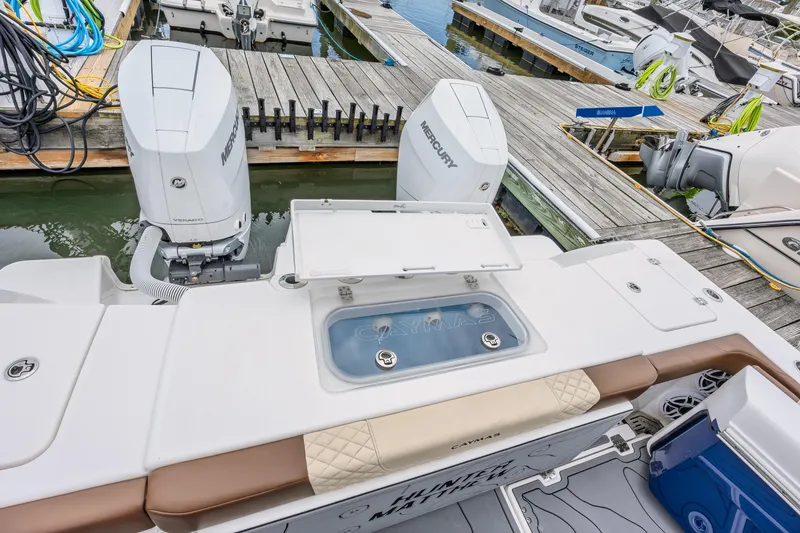 Slide: The Image of 2024 Caymas 34 CT boat with Mercury engines docked at marina. - 15
