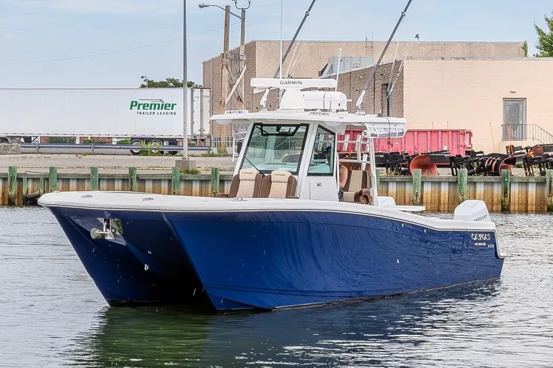 Slide: The Image of 2024 Caymas 34 CT boat with blue hull docked in a marina. - 5