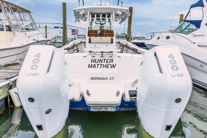 Slide: The Image of 2024 Caymas 34 CT boat docked, featuring dual Mercury 400 V10 engines. - 8
