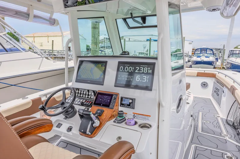 Slide: The Image of 2024 Caymas 34 CT boat cockpit with advanced navigation displays and luxurious seating. - 9