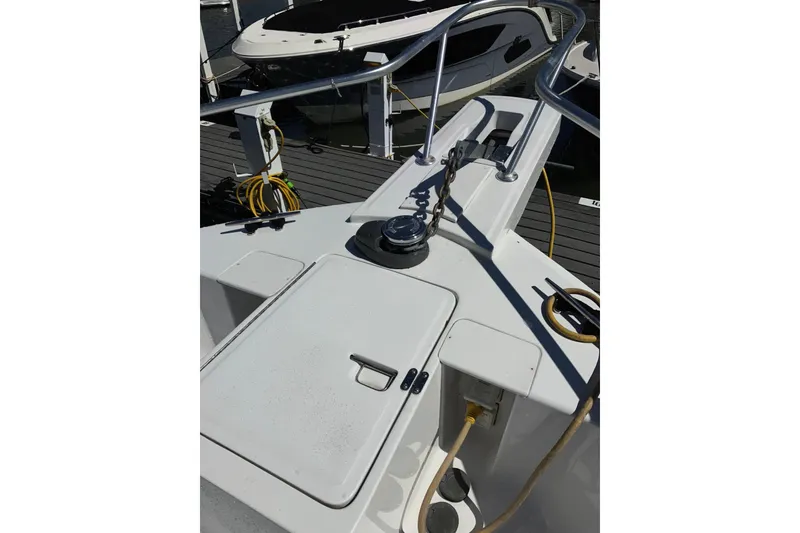 Slide: The Image of 1999 Mainship 350 Trawler deck with railing, docked at marina. - 7