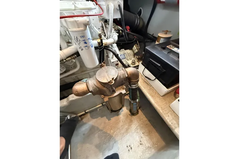 Slide: The Image of Engine room of 1999 Mainship 350 Trawler with visible components and battery. - 31