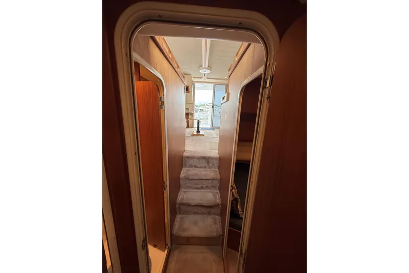 Slide: The Image of Interior view of 1999 Mainship 350 Trawler, featuring a narrow hallway and carpeted steps. - 29