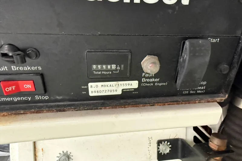 Slide: The Image of Control panel of a 1999 Mainship 350 Trawler showing 5589.1 total hours. - 36