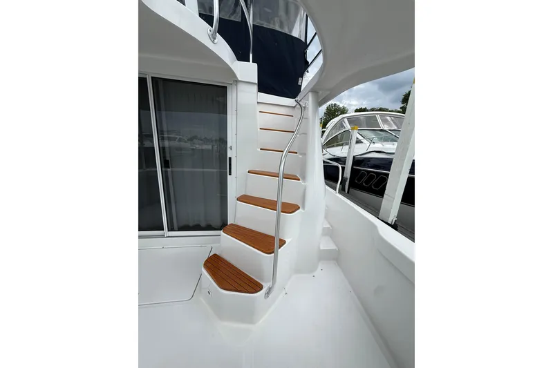 Slide: The Image of Staircase on 1999 Mainship 350 Trawler with wooden steps and metal railing. - 11