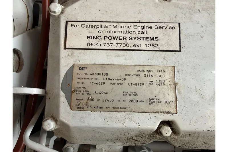 Slide: The Image of Caterpillar marine engine label on 1999 Mainship 350 Trawler, model 3116, with service contact details. - 30