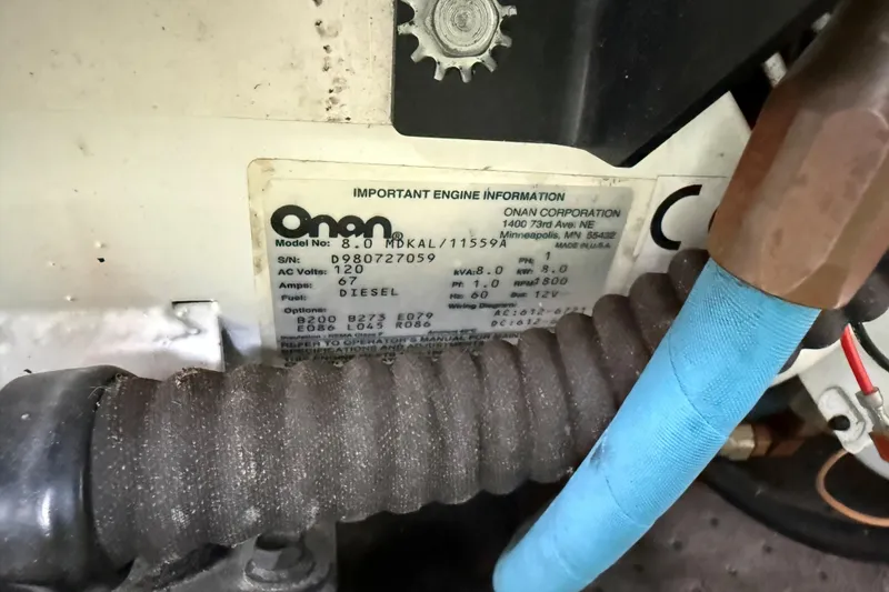 Slide: The Image of Close-up of Onan generator label on 1999 Mainship 350 Trawler, showing model and specifications. - 34