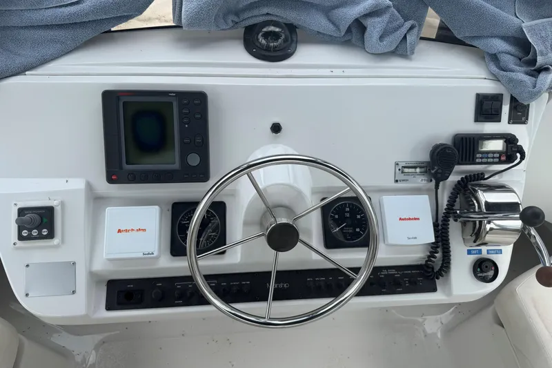 Slide: The Image of 1999 Mainship 350 Trawler helm with navigation instruments and steering wheel. - 14