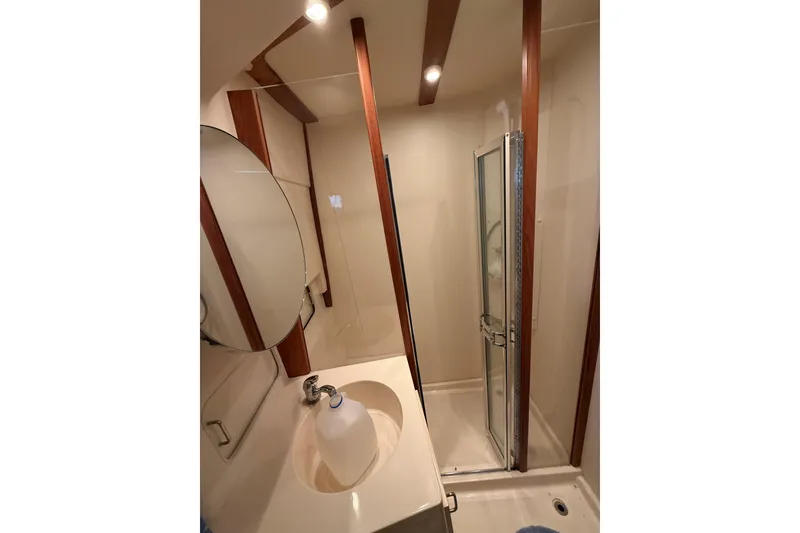 Slide: The Image of Bathroom interior of 1999 Mainship 350 Trawler with shower and sink. - 28
