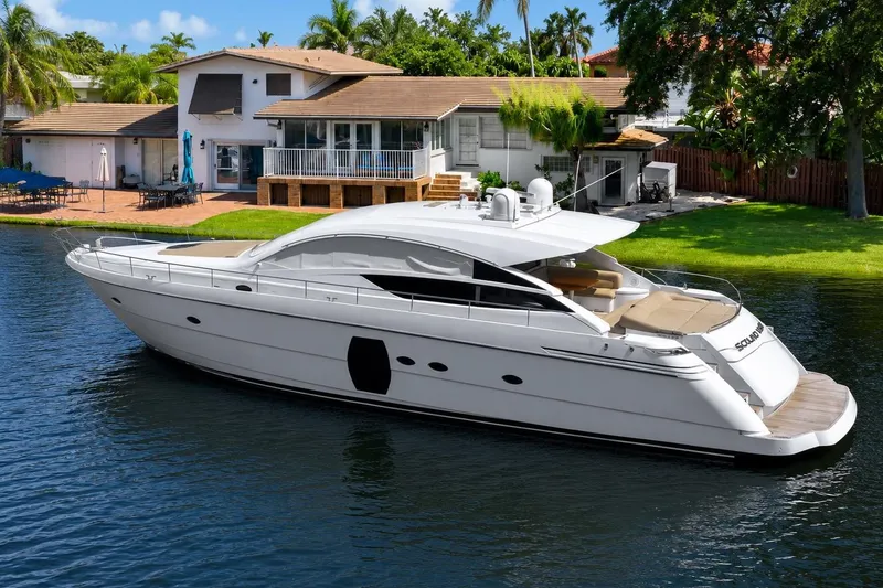 The Image of Luxury 2013 Pershing 64 yacht docked by a waterfront home, showcasing sleek design. - 0