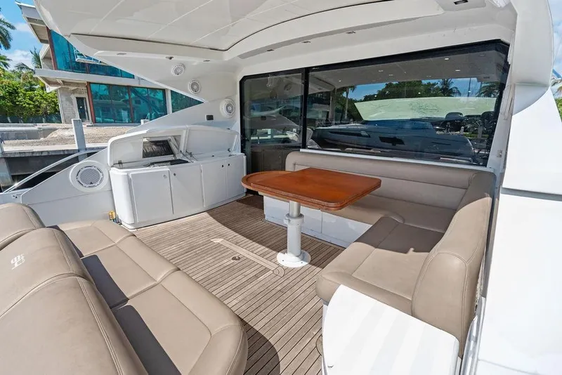 Slide: The Image of Luxurious 2013 Pershing 64 yacht interior with seating and table on deck. - 15