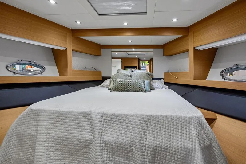 Slide: The Image of Luxurious bedroom interior of 2013 Pershing 64 yacht with modern design and cozy bedding. - 18