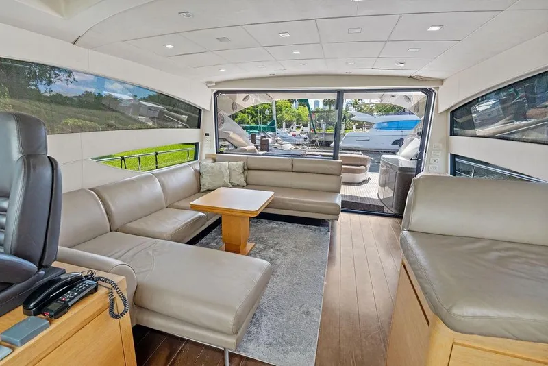 Slide: The Image of Luxurious interior of 2013 Pershing 64 yacht with leather seating and large windows. - 19